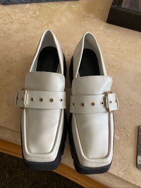 Charles & Keith White Loafers with Gold Buckle and Black Sole